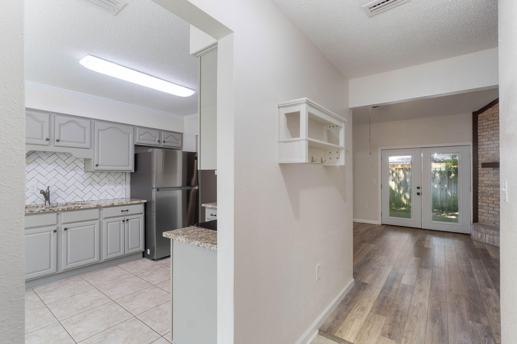 634 Lloyd Street Fort Walton Beach, FL 32547 - Photo 5 of 27 a kitchen with stainless steel appliances granite countertop a refrigerator and a sink