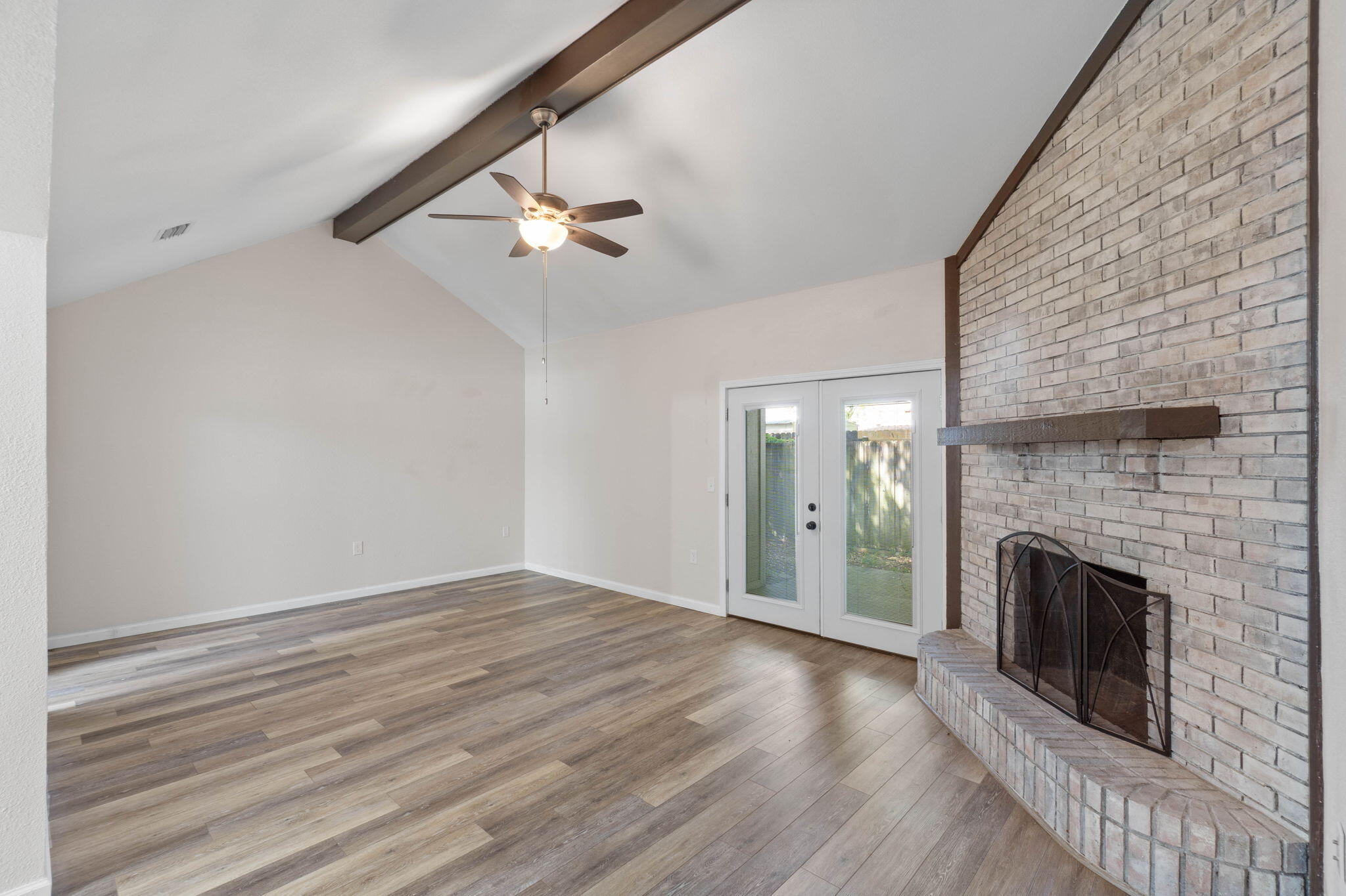 634 Lloyd Street Fort Walton Beach, FL 32547 - Photo 6 of 27 an empty room with wooden floor a fireplace