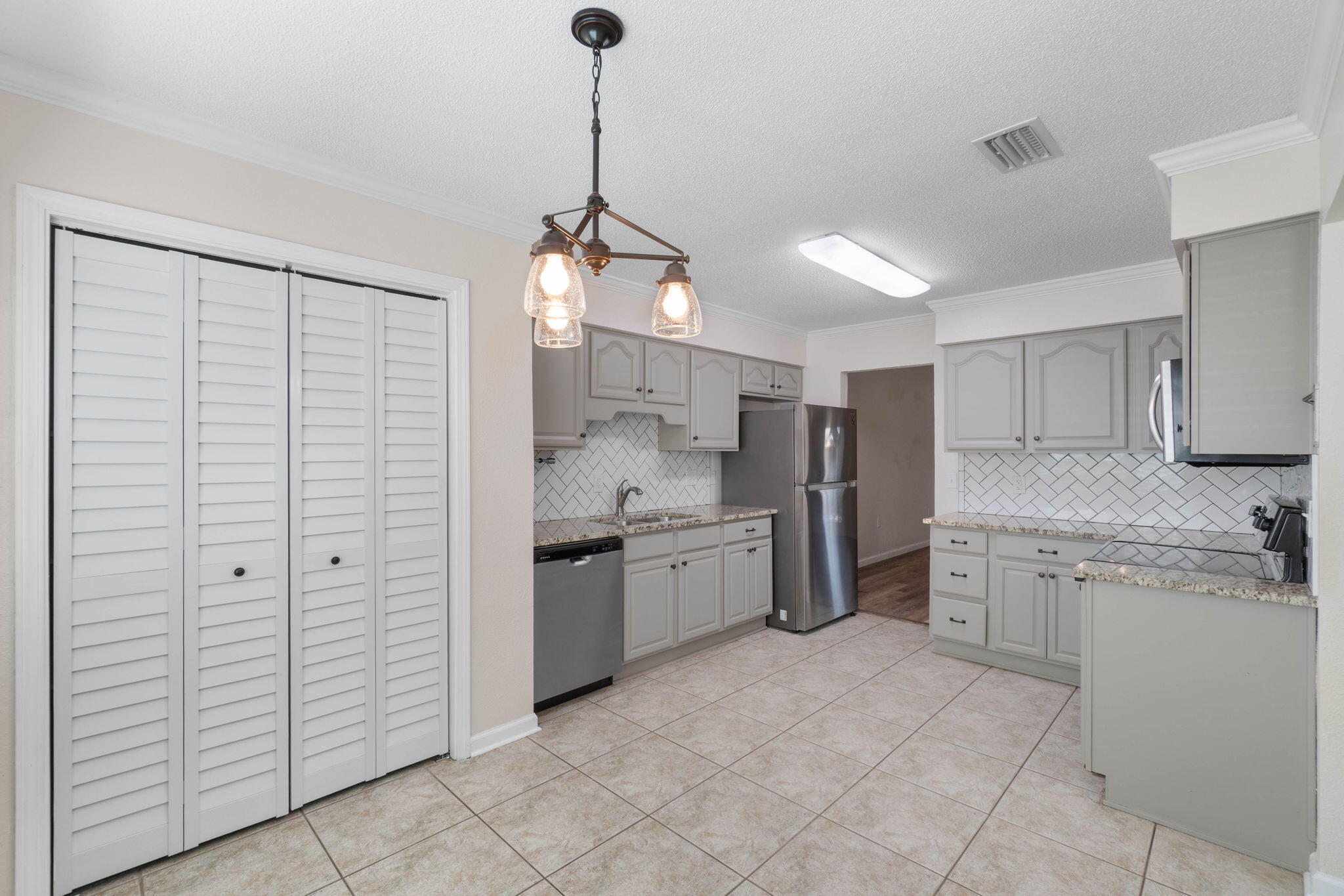 634 Lloyd Street Fort Walton Beach, FL 32547 - Photo 10 of 27 a large kitchen with cabinets and stainless steel appliances
