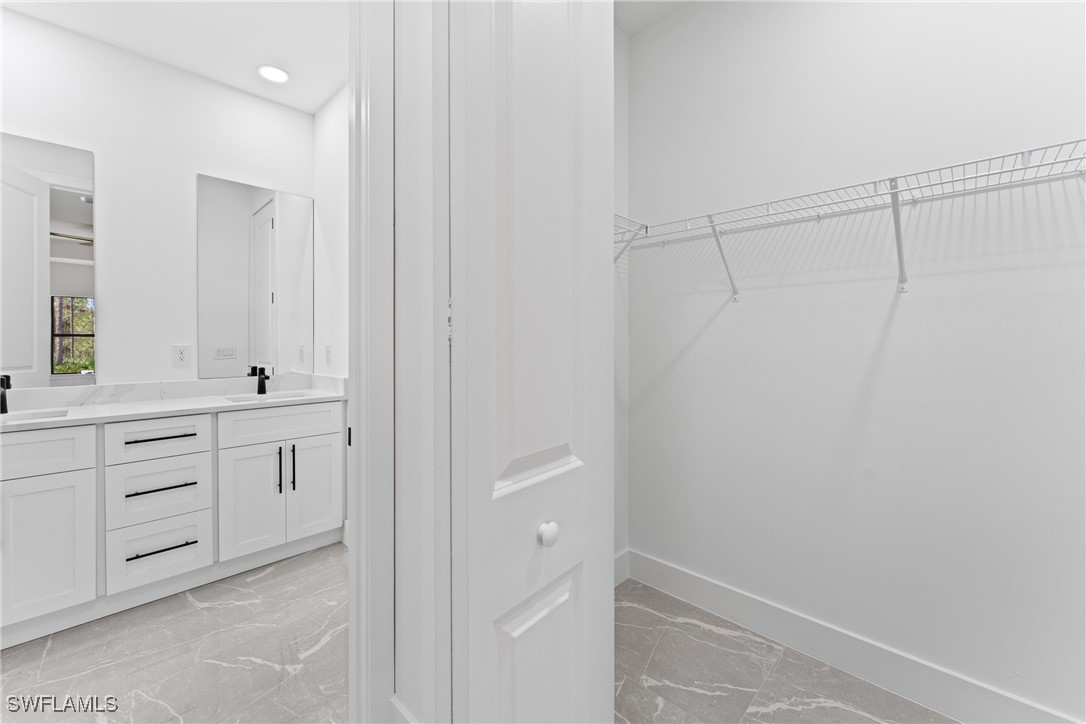 1024 Chauncey Avenue Lehigh Acres, FL 33971 - Photo 12 of 39 a bathroom with a double vanity sink a toilet and a mirror