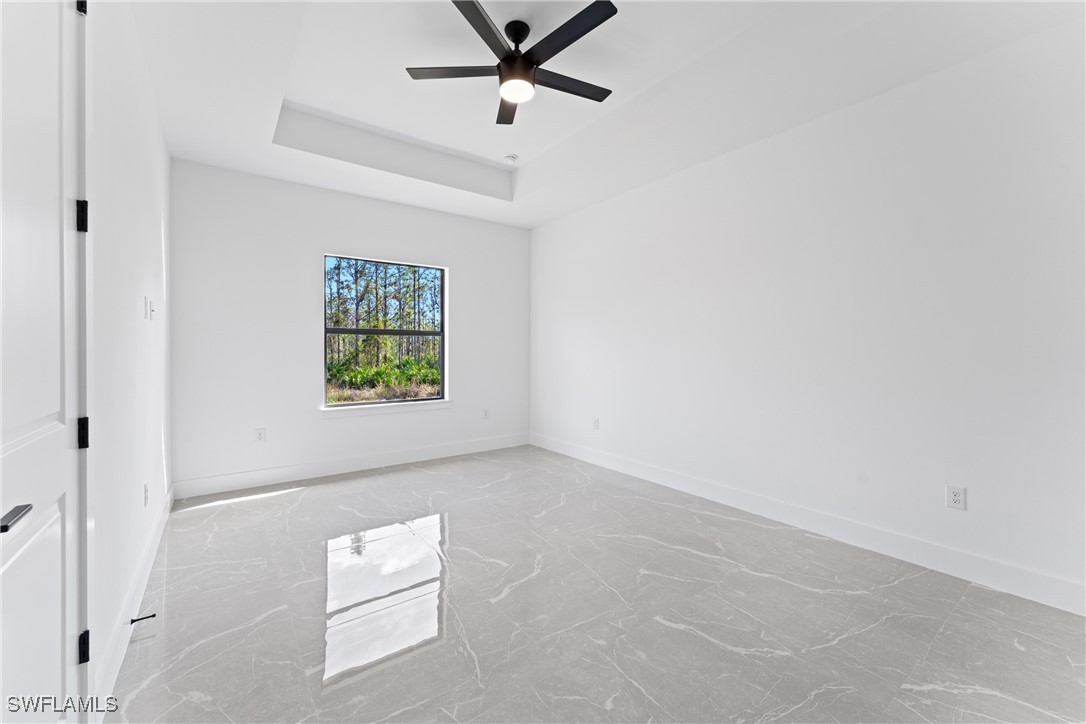 1024 Chauncey Avenue Lehigh Acres, FL 33971 - Photo 15 of 39 an empty room with windows and ceiling fan
