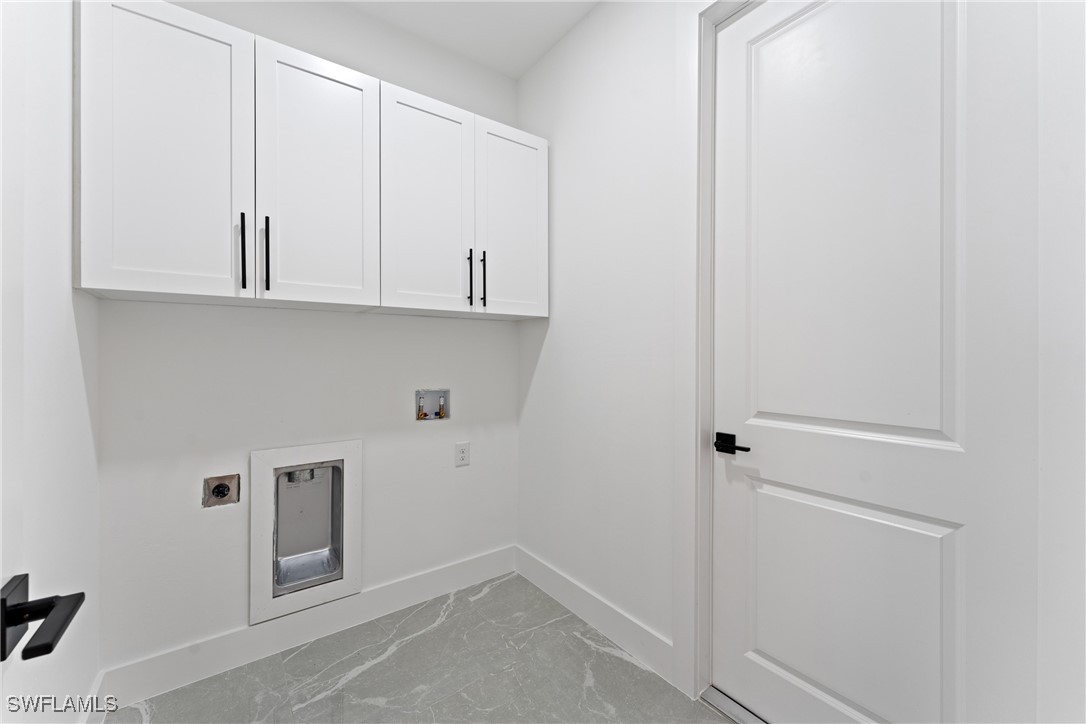 1024 Chauncey Avenue Lehigh Acres, FL 33971 - Photo 28 of 39 a view of cabinets and utility room with closet