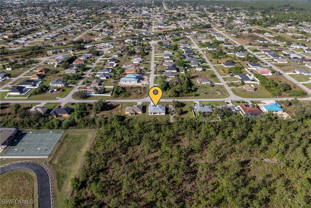1024 Chauncey Avenue Lehigh Acres, FL 33971 - Photo 34 of 39 an aerial view of a house with a swimming pool