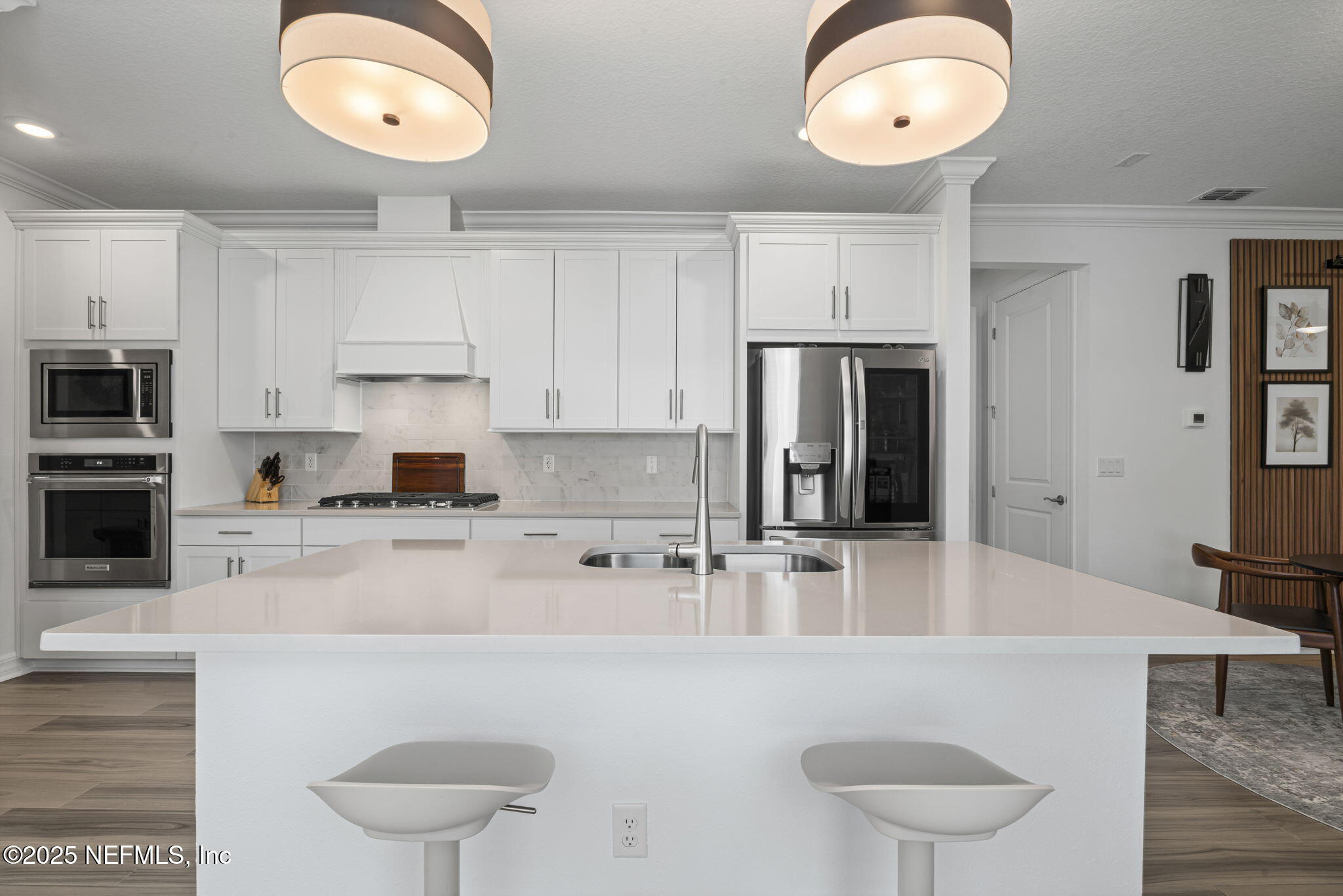 217 Fairlake Cir Street St. Augustine, FL 32092 - Photo 11 of 47 a kitchen with stainless steel appliances granite countertop a stove a sink a refrigerator white cabinets and chairs