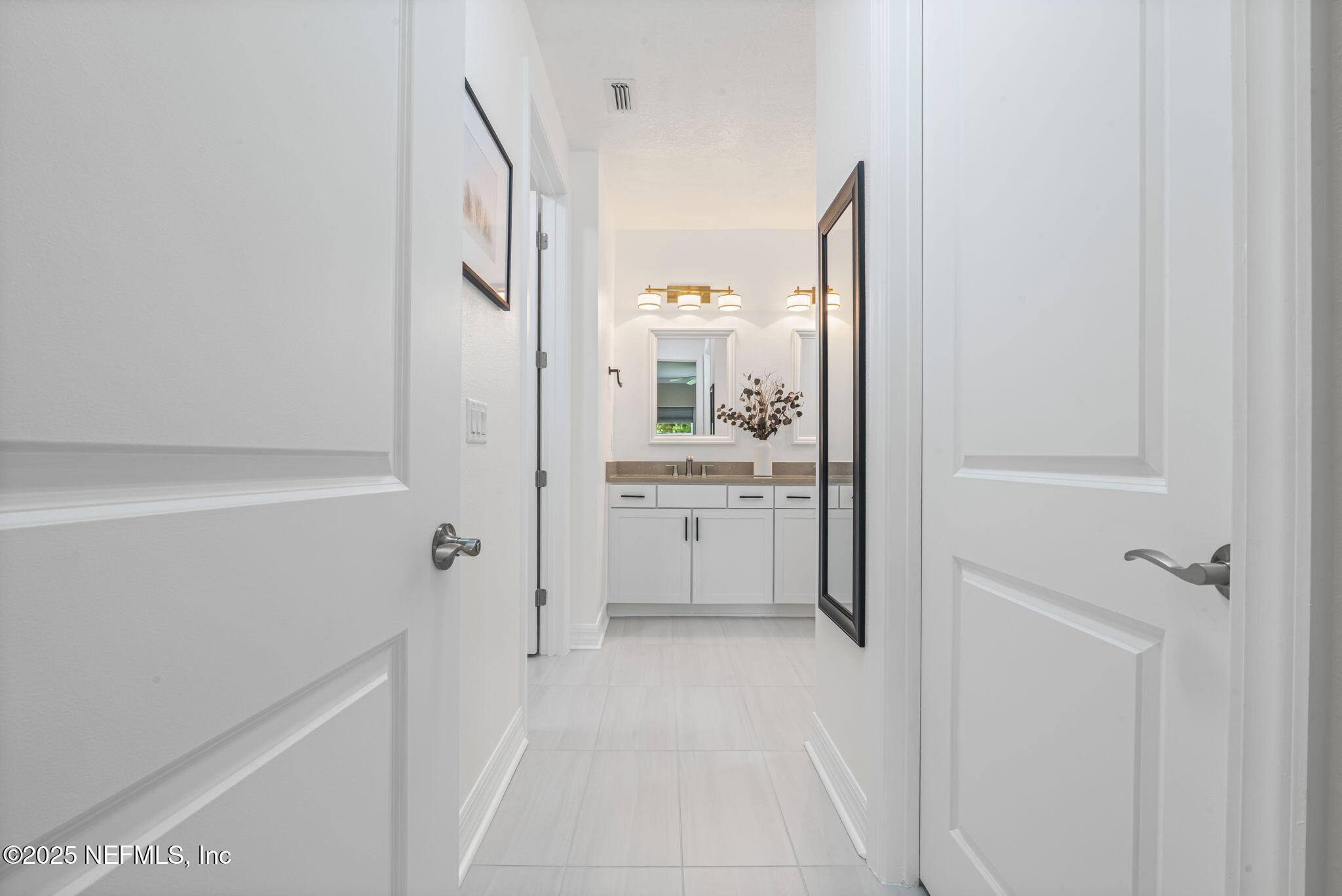 217 Fairlake Cir Street St. Augustine, FL 32092 - Photo 25 of 47 a bathroom with a sink and a mirror