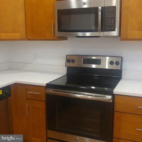 a stove top oven sitting inside of a kitchen