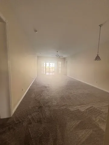 a view of room and hall with a window