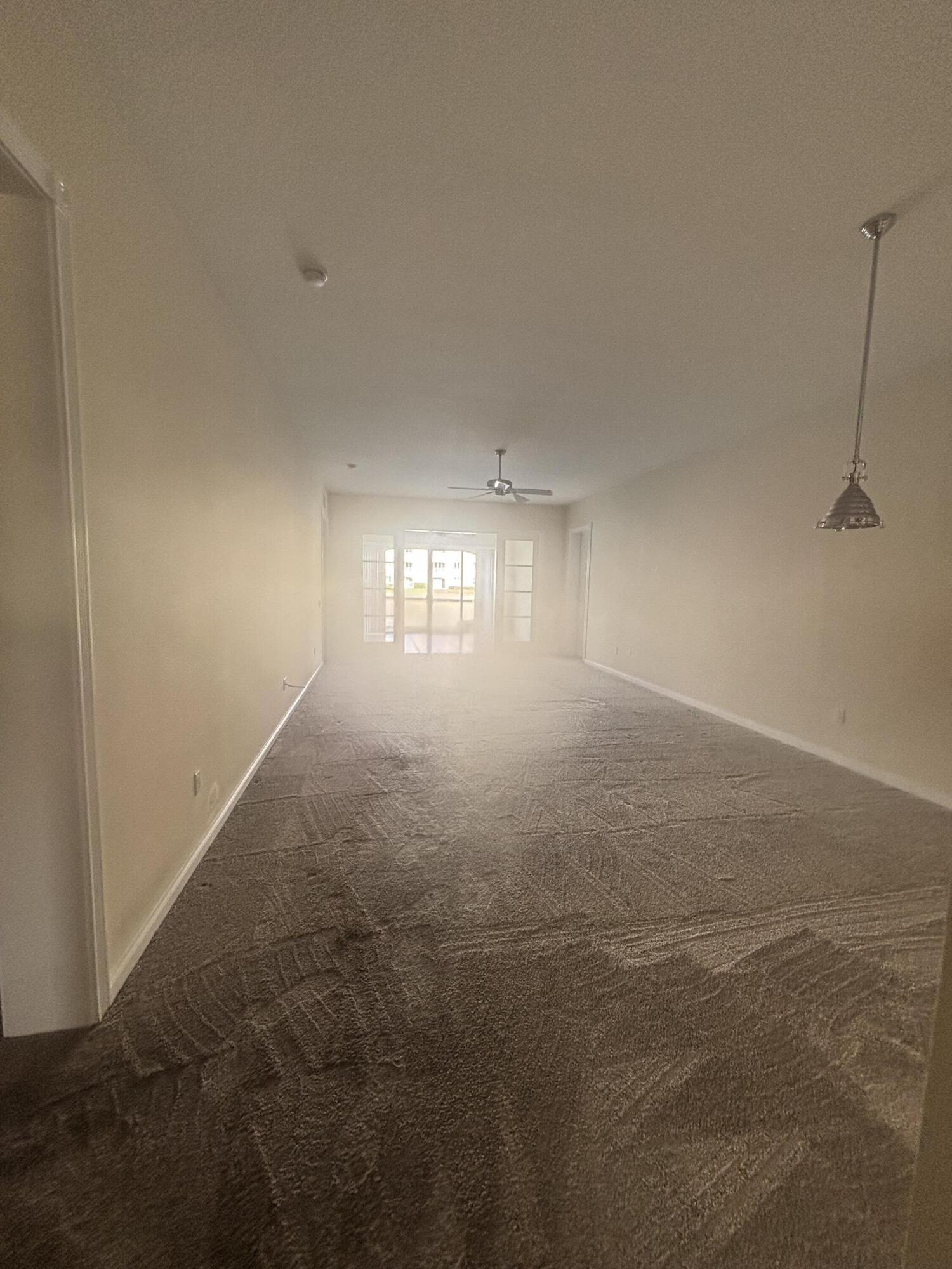 17 Harbour Isle Drive West, Unit 103 Fort Pierce, FL 34949 - Photo 5 of 17 a view of room and hall with a window