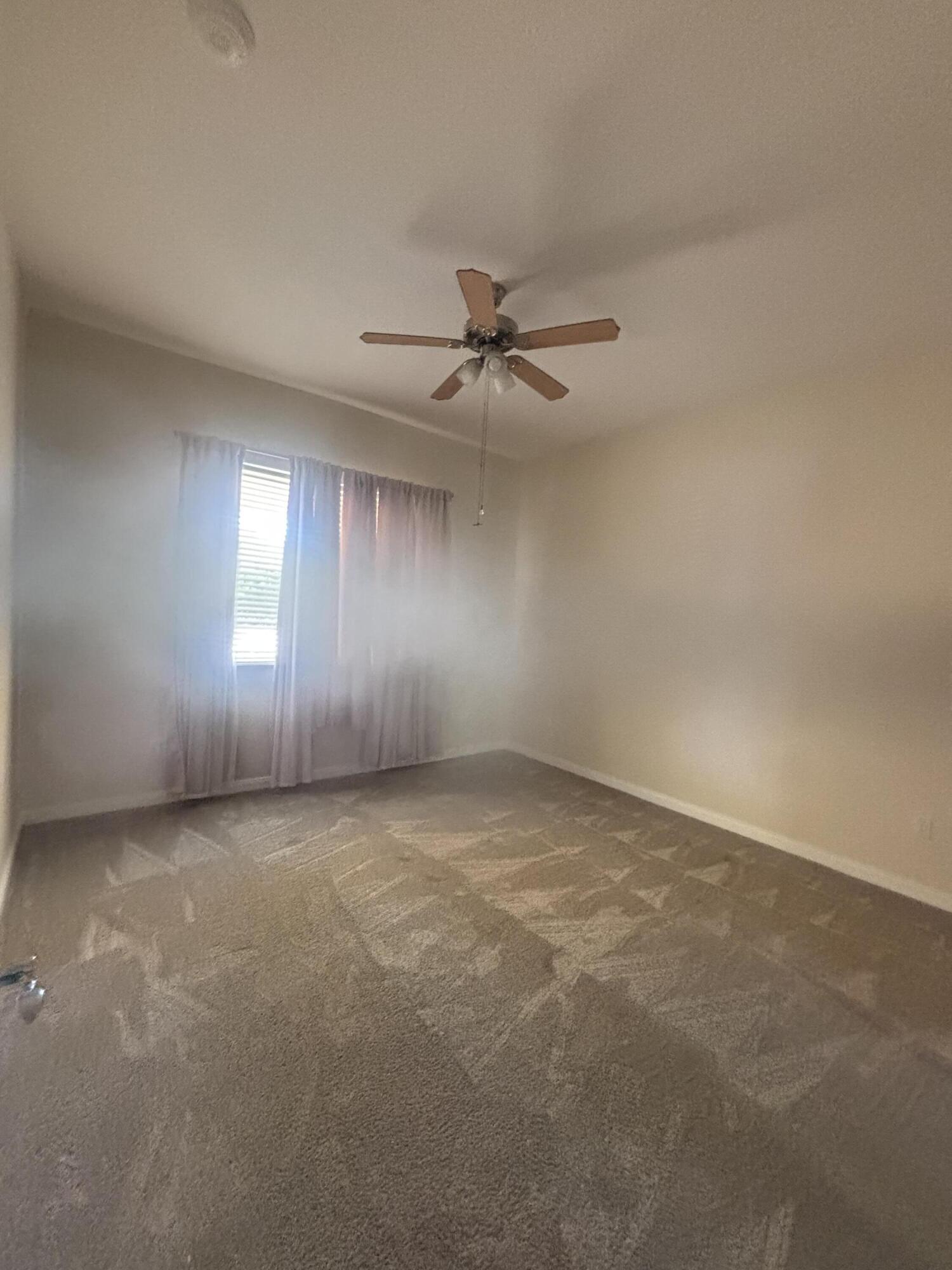 17 Harbour Isle Drive West, Unit 103 Fort Pierce, FL 34949 - Photo 8 of 17 an empty room with windows and fan
