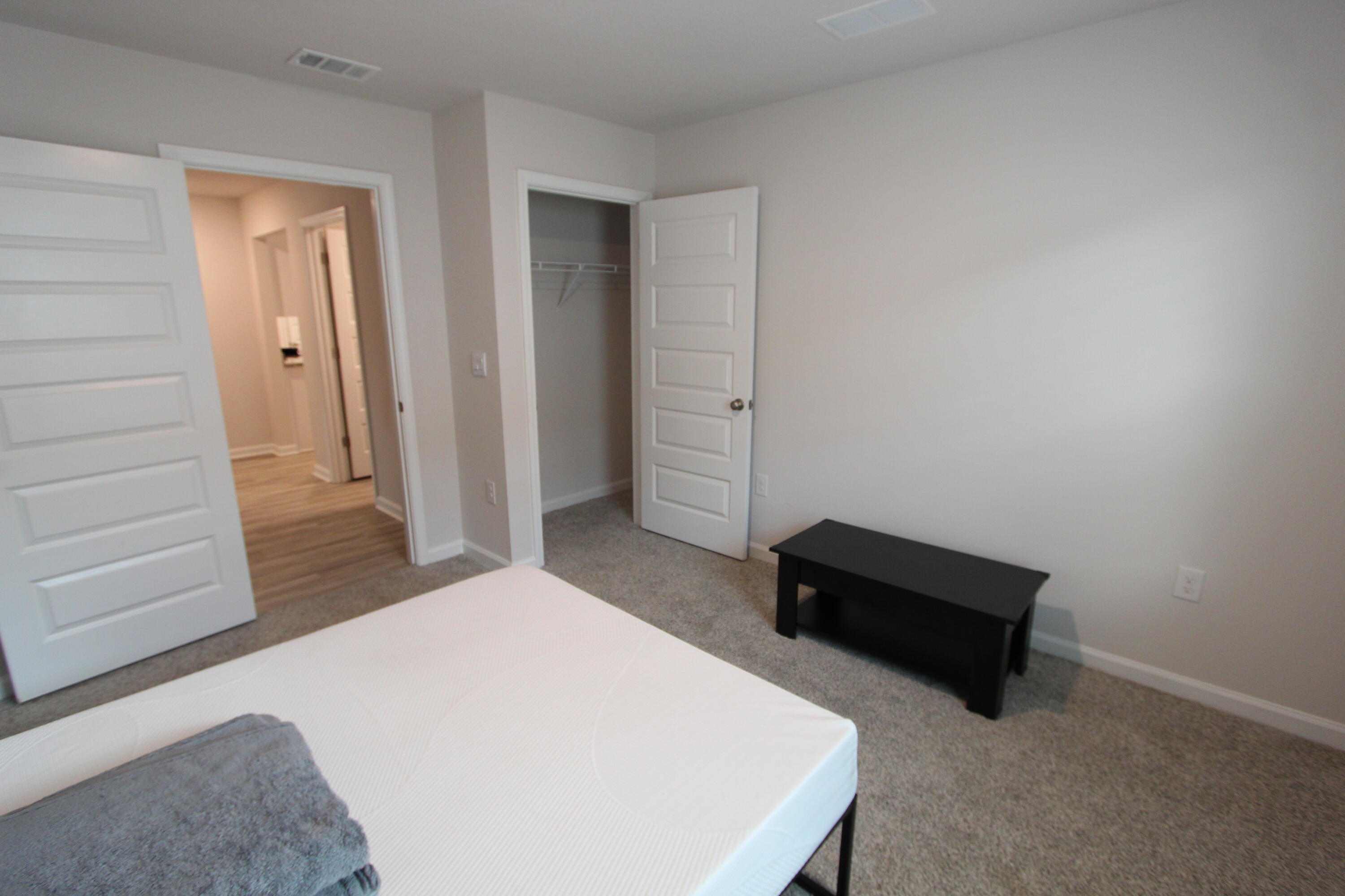 3063 Jane Lane Crestview, FL 32539 - Photo 13 of 30 a bedroom with a bed and a dresser