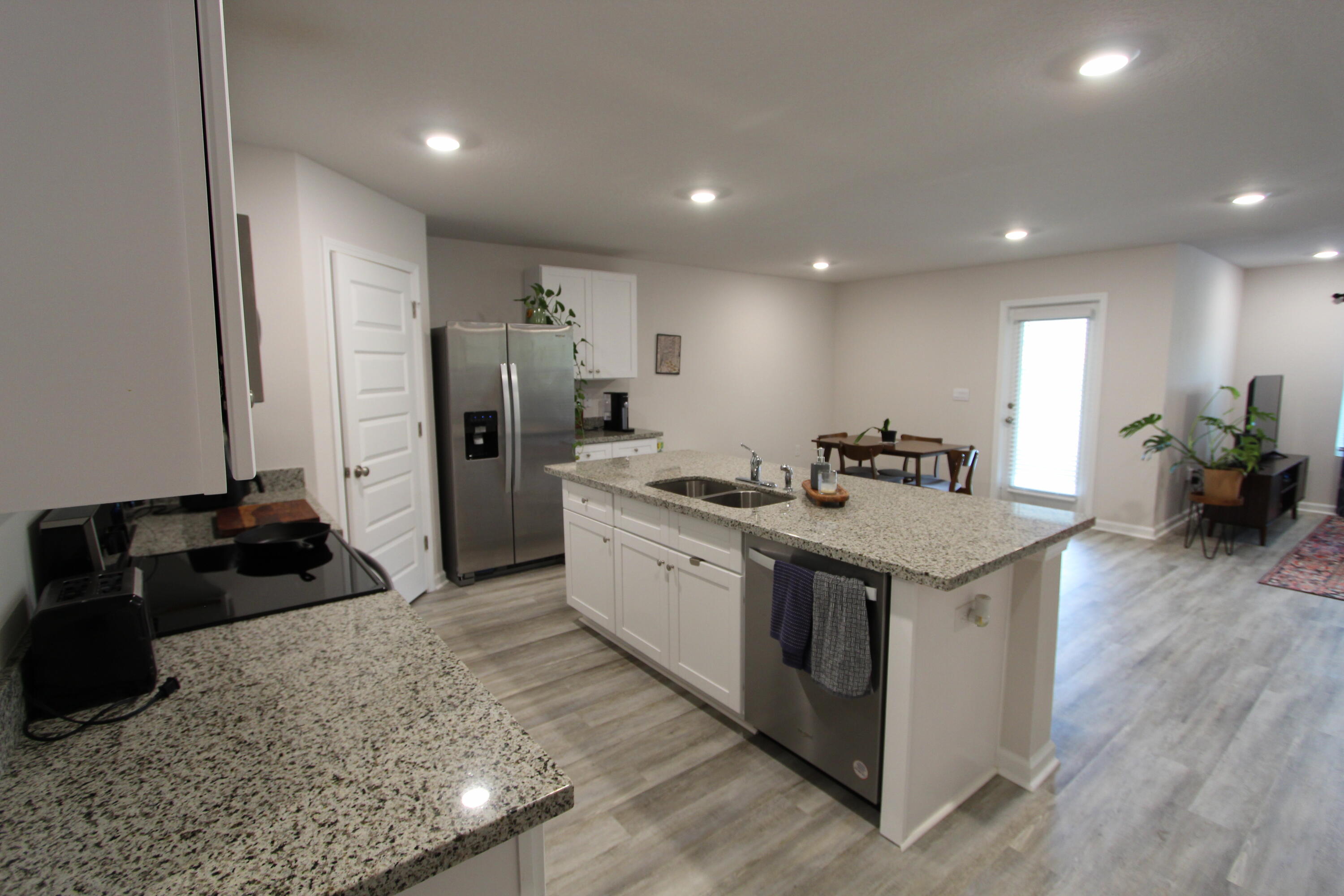 3063 Jane Lane Crestview, FL 32539 - Photo 18 of 30 a kitchen with stainless steel appliances granite countertop a sink stove and refrigerator