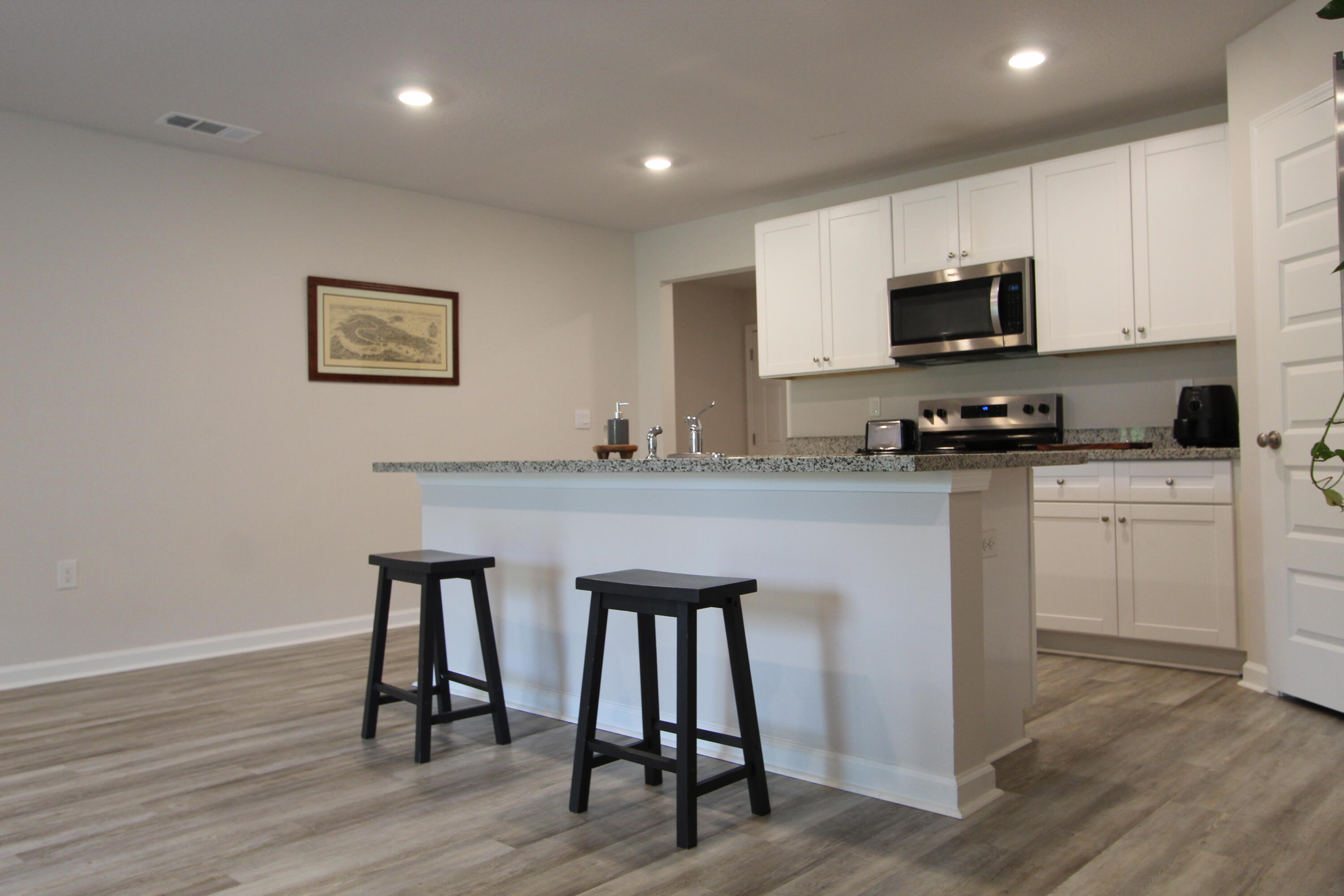 3063 Jane Lane Crestview, FL 32539 - Photo 19 of 30 a kitchen with white cabinets a sink and appliances
