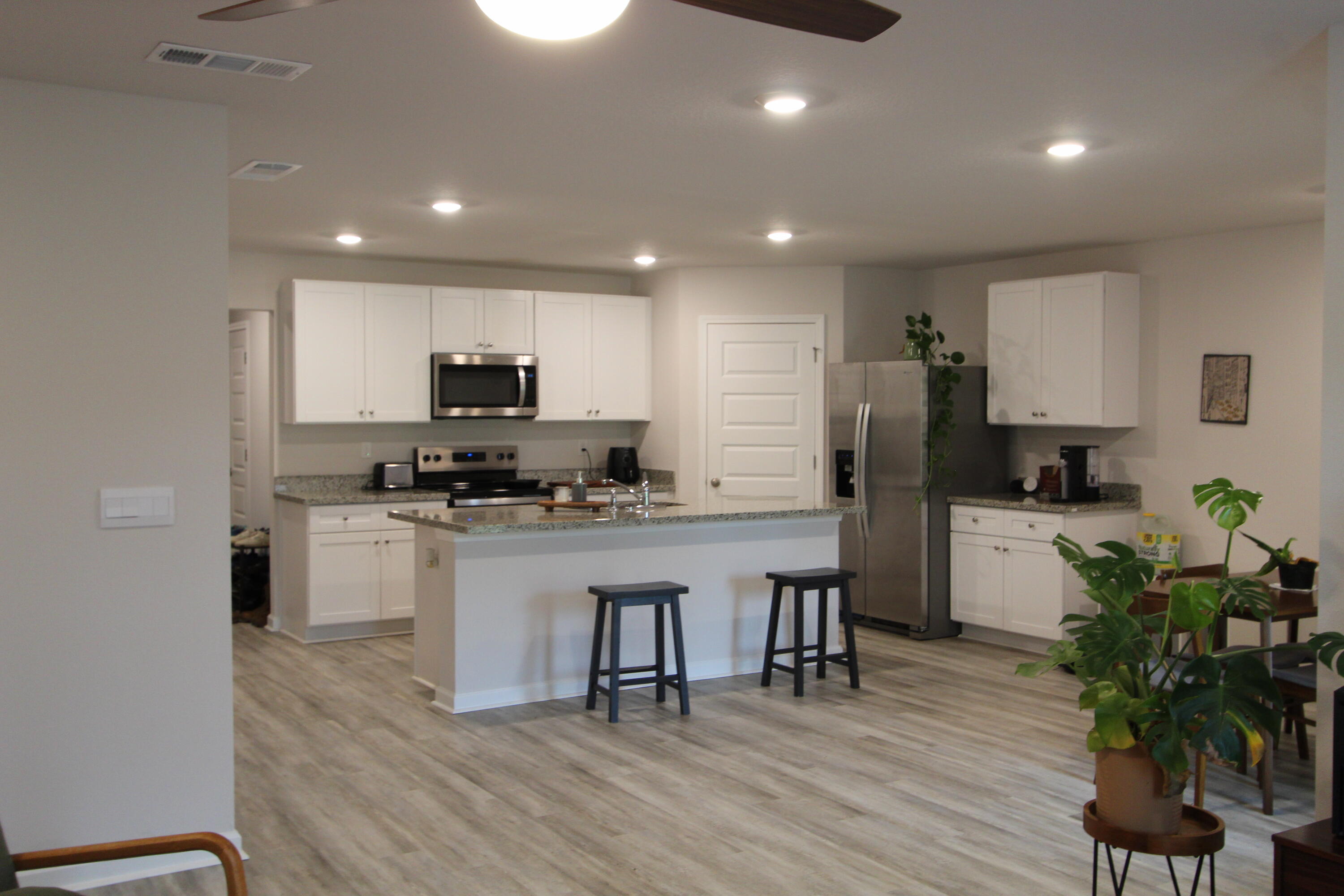 3063 Jane Lane Crestview, FL 32539 - Photo 20 of 30 a kitchen with sink a refrigerator and microwave