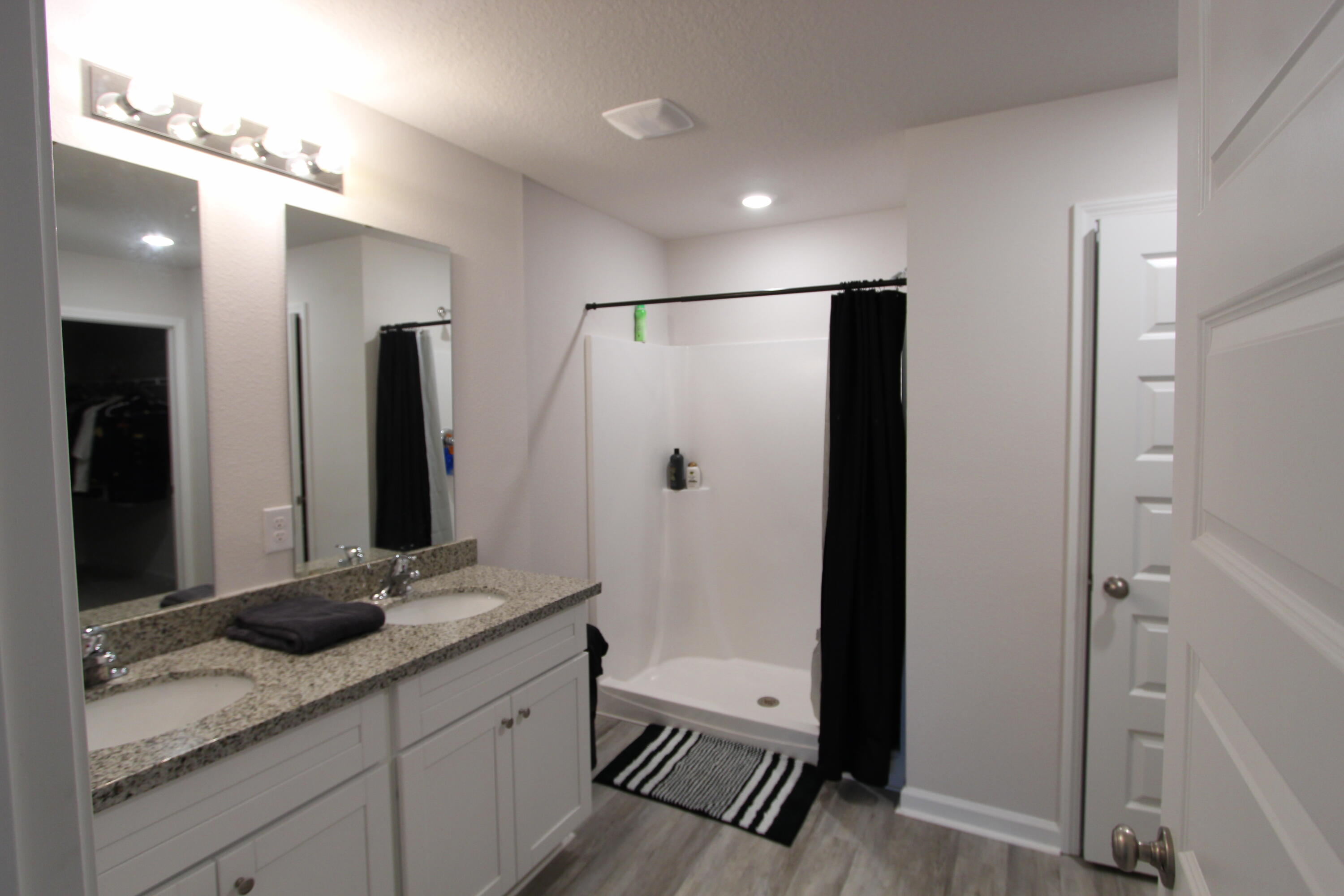 3063 Jane Lane Crestview, FL 32539 - Photo 27 of 30 a bathroom with a granite countertop sink a shower and a mirror