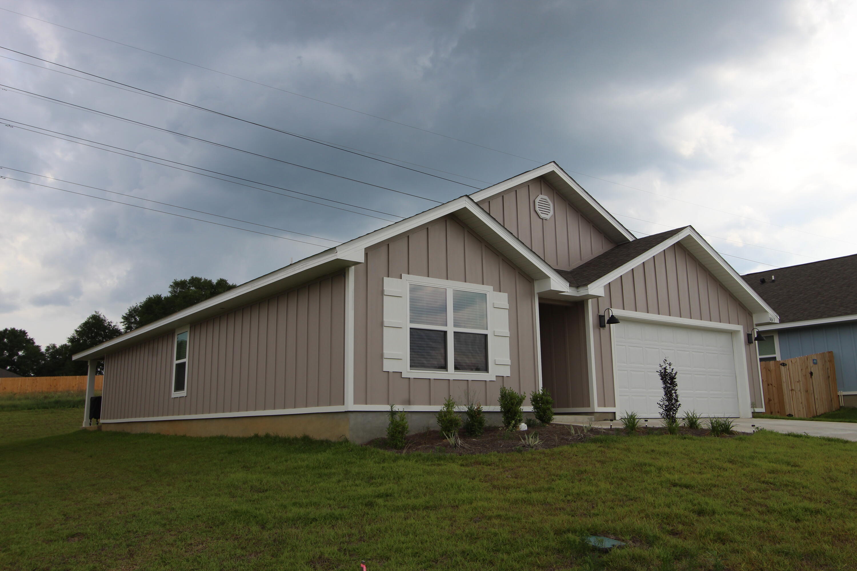 3063 Jane Lane Crestview, FL 32539 - Photo 3 of 30 a front view of a house with a garden