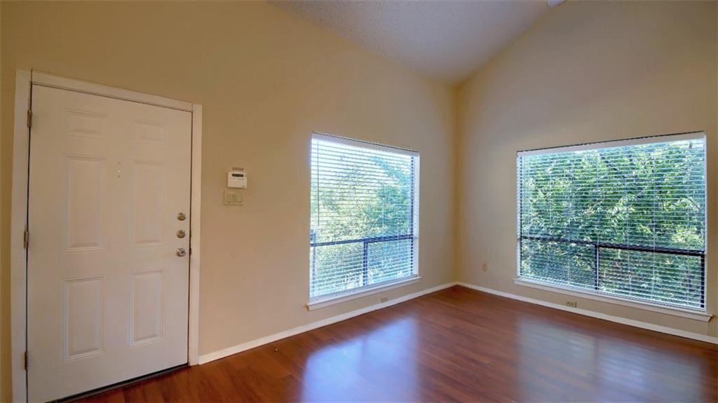 908 Poplar Street, Unit 203 Austin, TX 78705 - Photo 4 of 9 a view of an empty room with wooden floor and a window