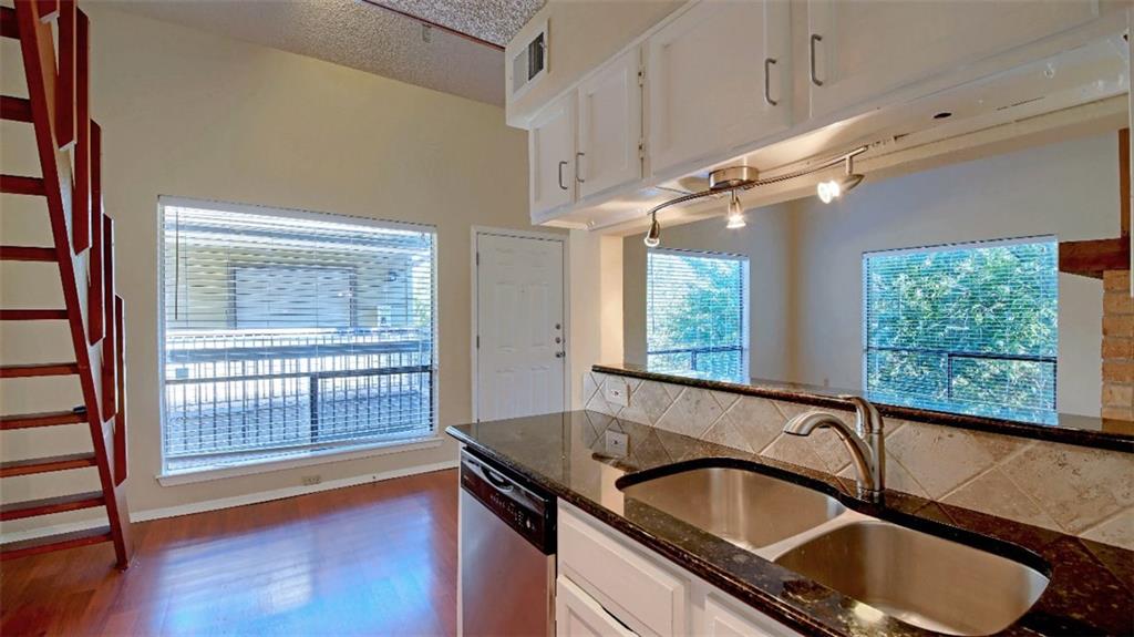 908 Poplar Street, Unit 203 Austin, TX 78705 - Photo 7 of 9 a kitchen with granite countertop a sink and a window