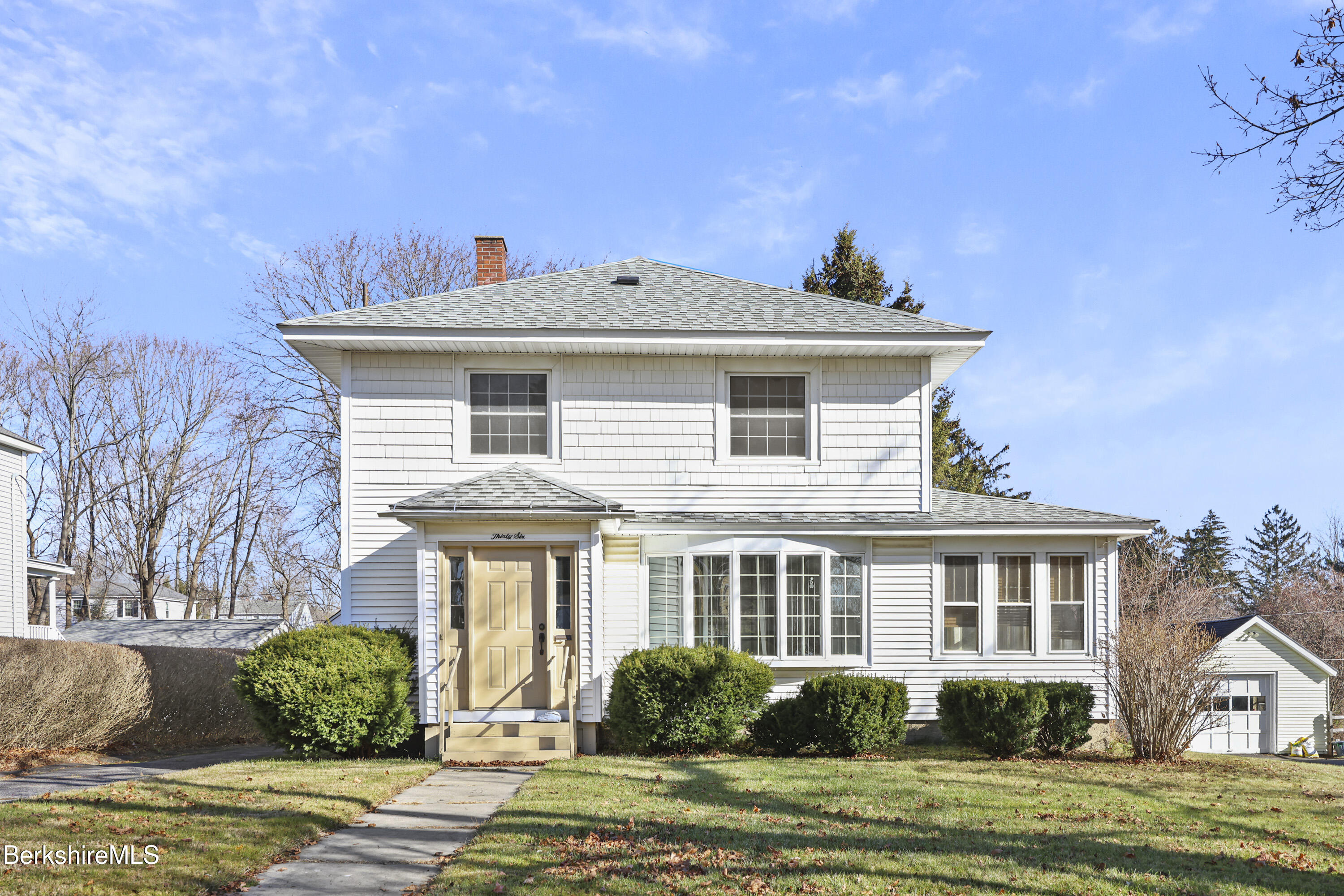 a front view of a house with a yard