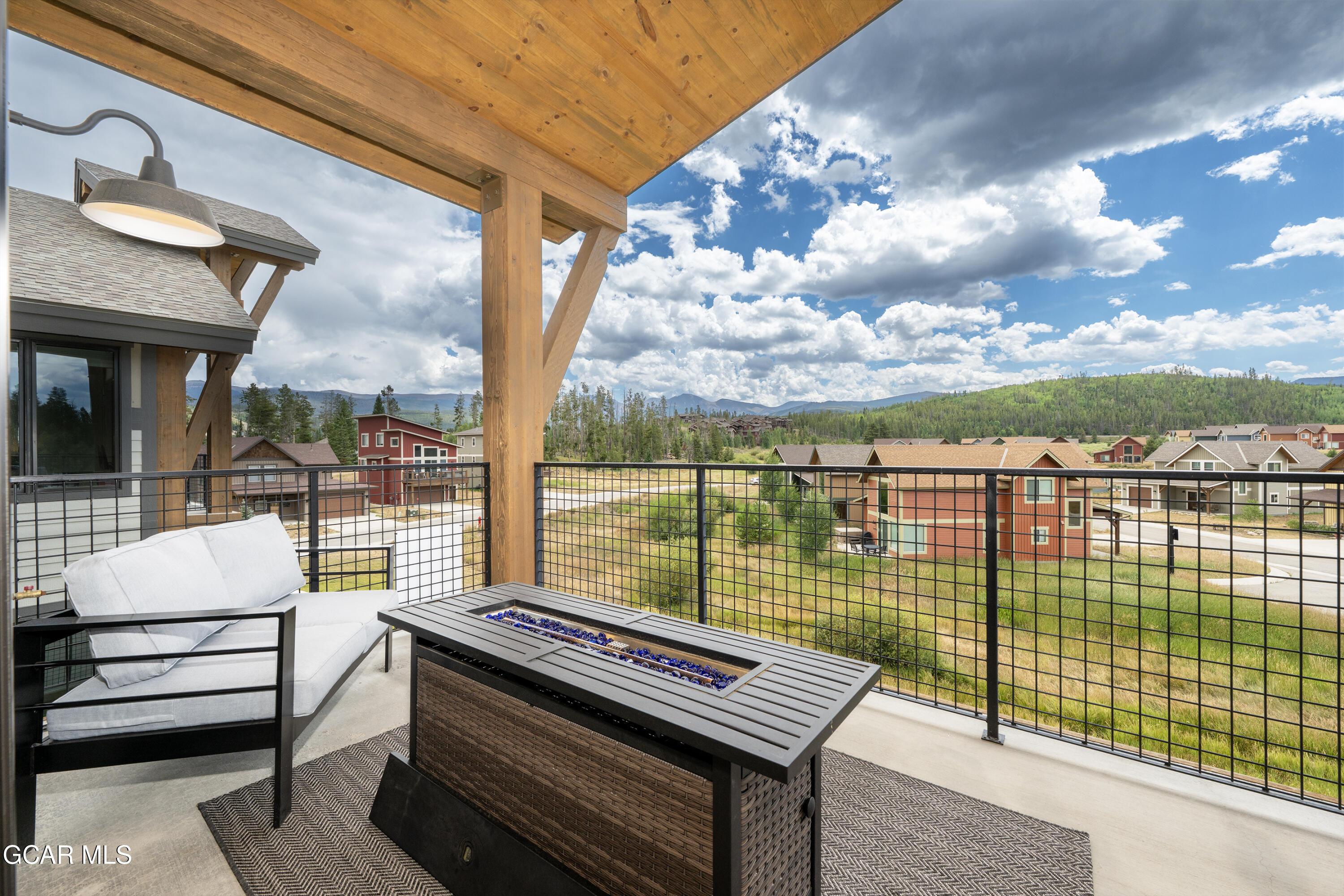 96 Meadow Trail, Unit G304 Fraser, CO 80442 - Photo 3 of 37 a view of a balcony with lake view and a potted plant