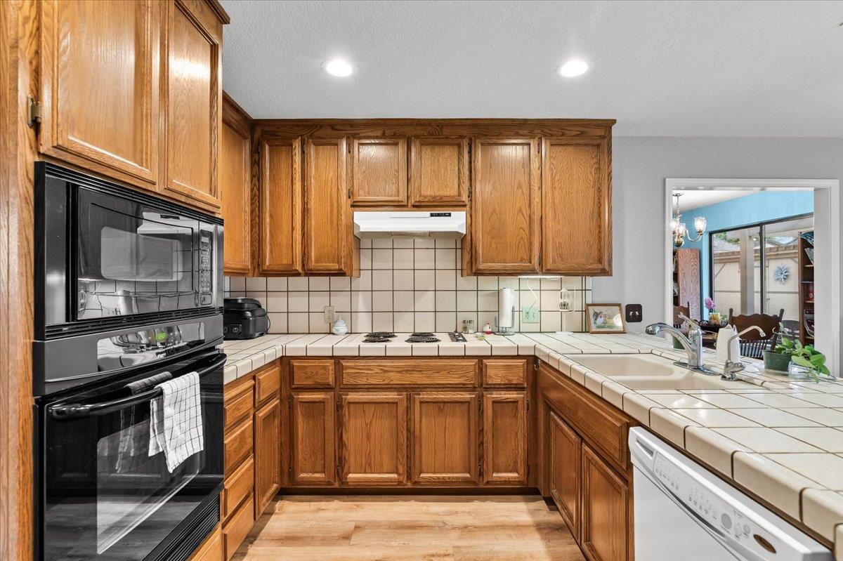 2136 Candy Cane Walk Manteca, CA 95336 - Photo 21 of 60 a kitchen with a sink stove top oven and cabinets