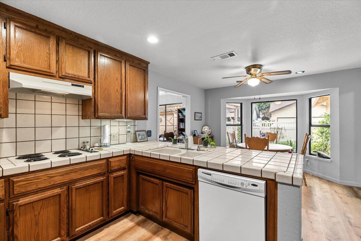 2136 Candy Cane Walk Manteca, CA 95336 - Photo 22 of 60 a kitchen with stainless steel appliances granite countertop a sink stove and cabinets