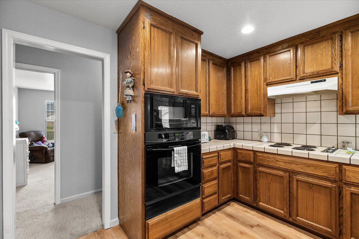 2136 Candy Cane Walk Manteca, CA 95336 - Photo 24 of 60 a kitchen with a sink cabinets and stainless steel appliances