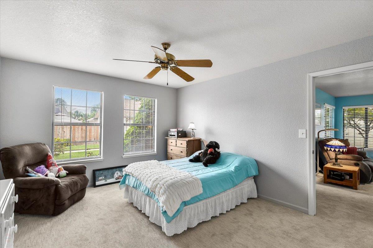 2136 Candy Cane Walk Manteca, CA 95336 - Photo 27 of 60 a bedroom with a bed a couch and a window