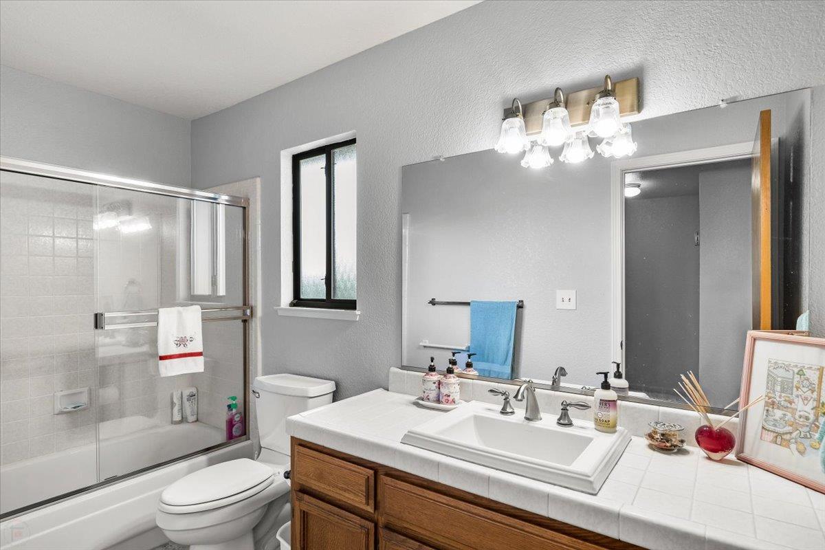 2136 Candy Cane Walk Manteca, CA 95336 - Photo 28 of 60 a bathroom with a sink vanity granite toilet and shower