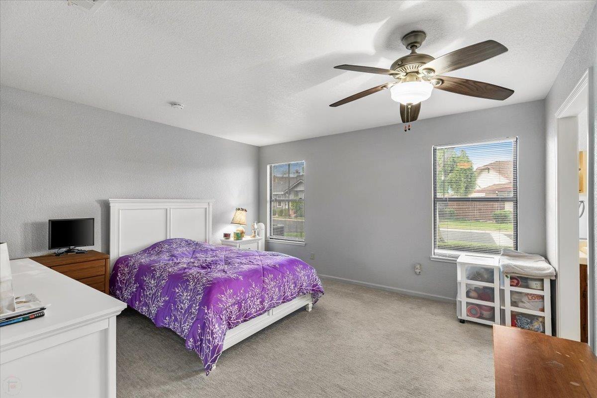 2136 Candy Cane Walk Manteca, CA 95336 - Photo 30 of 60 a bedroom with a bed and a flat screen tv
