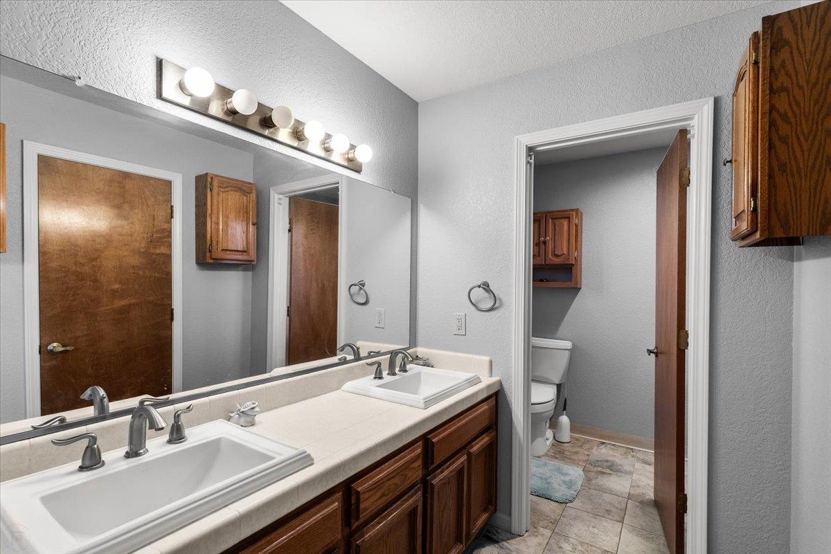 2136 Candy Cane Walk Manteca, CA 95336 - Photo 33 of 60 a bathroom with a sink double vanity and a mirror
