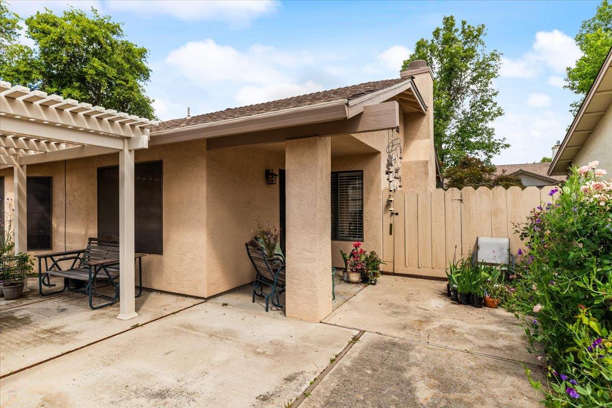2136 Candy Cane Walk Manteca, CA 95336 - Photo 39 of 60 a view of a house with potted plants in front of door