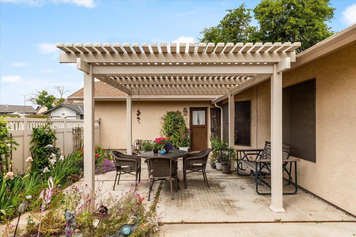 2136 Candy Cane Walk Manteca, CA 95336 - Photo 40 of 60 a view of a patio with table and chairs potted plants and floor to ceiling window