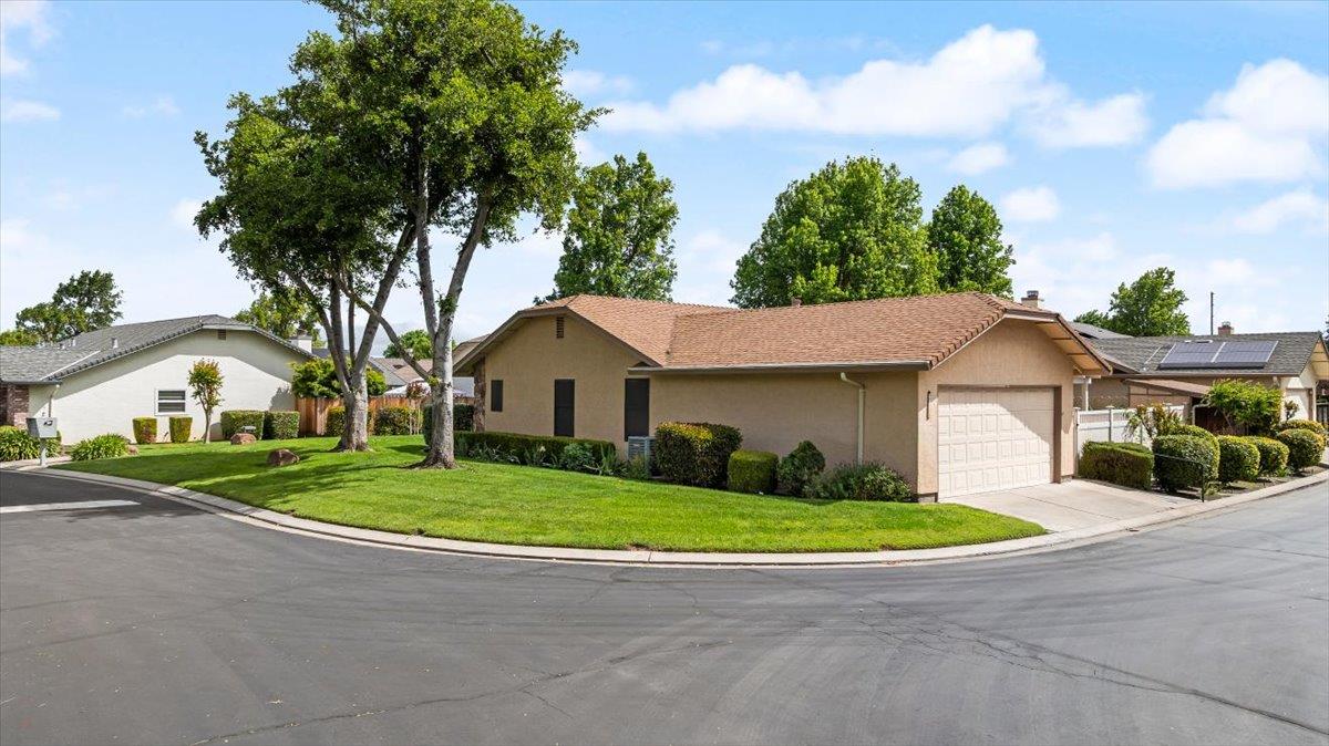 2136 Candy Cane Walk Manteca, CA 95336 - Photo 4 of 60 a front view of a house with a yard and garage