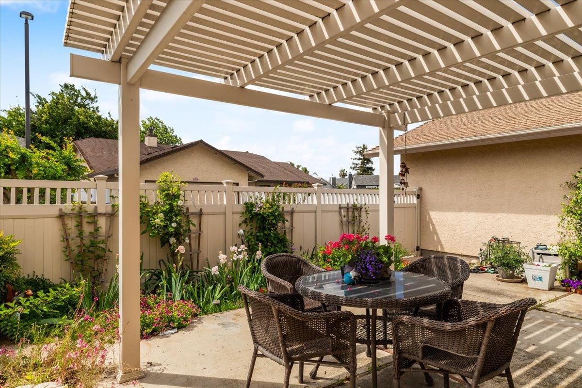 2136 Candy Cane Walk Manteca, CA 95336 - Photo 41 of 60 a view of a patio with table and chairs potted plants