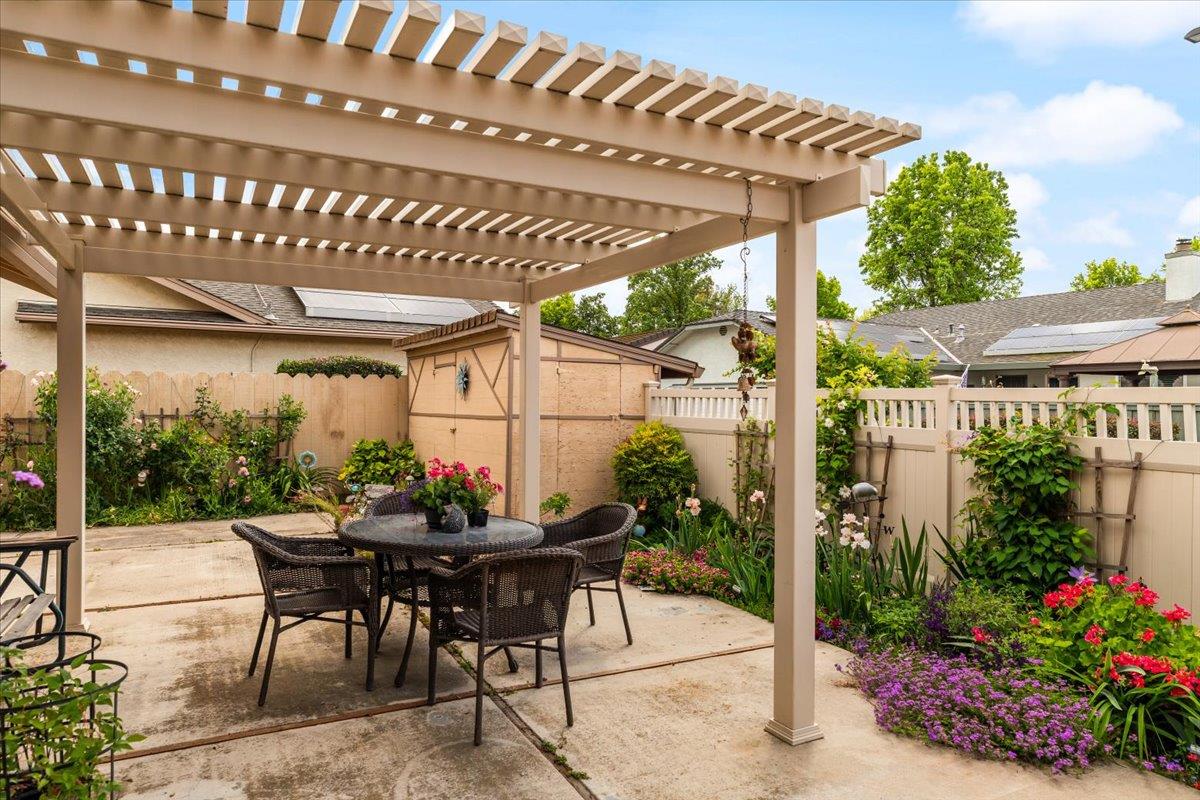 2136 Candy Cane Walk Manteca, CA 95336 - Photo 42 of 60 fenced backyard featuring outdoor dining area, a storage unit, and a patio