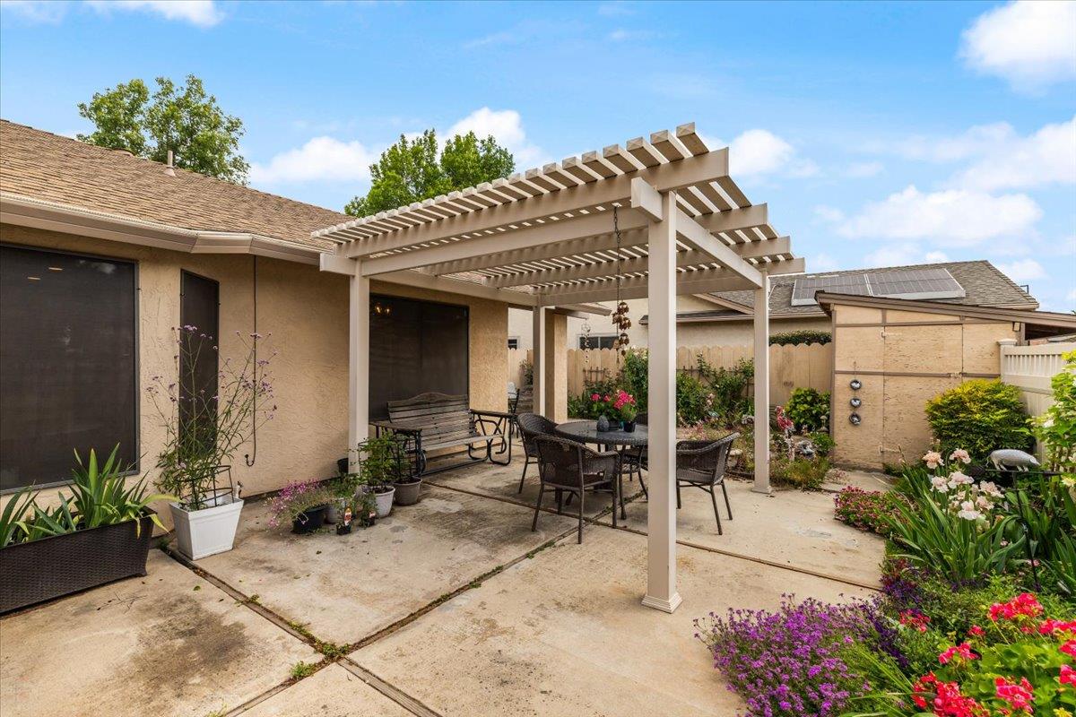 2136 Candy Cane Walk Manteca, CA 95336 - Photo 43 of 60 a view of a patio with table and chairs potted plants