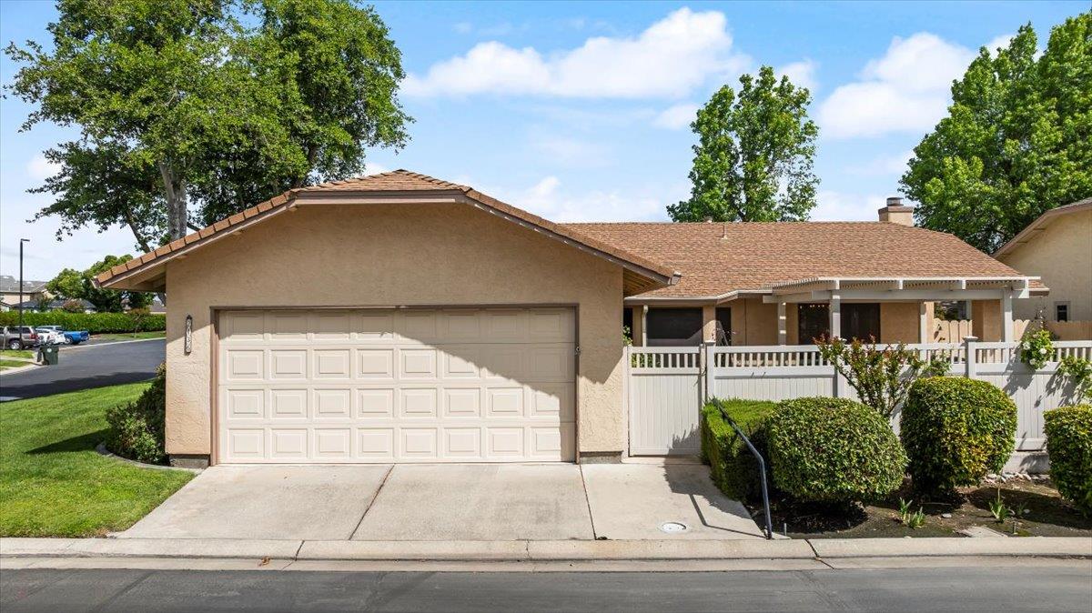 2136 Candy Cane Walk Manteca, CA 95336 - Photo 45 of 60 ranch-style house featuring stucco siding, an attached garage, driveway, and a chimney