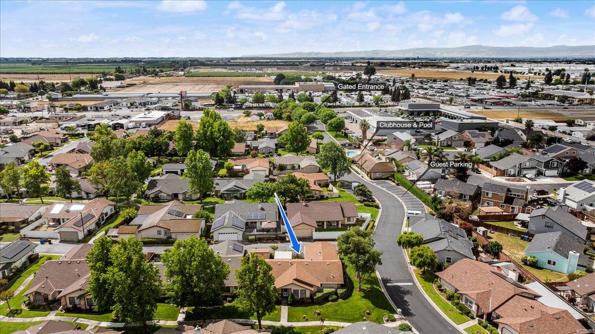 2136 Candy Cane Walk Manteca, CA 95336 - Photo 48 of 60 an aerial view of a city with lots of residential buildings and mountain view in back