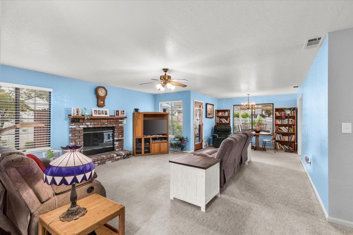 2136 Candy Cane Walk Manteca, CA 95336 - Photo 9 of 60 a living room with furniture and a fireplace