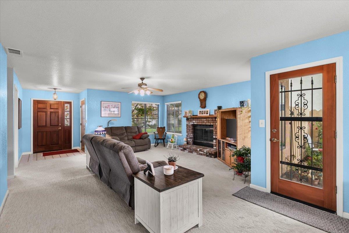 2136 Candy Cane Walk Manteca, CA 95336 - Photo 10 of 60 a living room with furniture and a fireplace