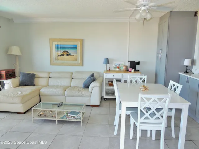 a dining room with furniture and a chandelier