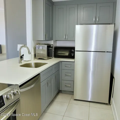 a living room with furniture and a dining table with garden view