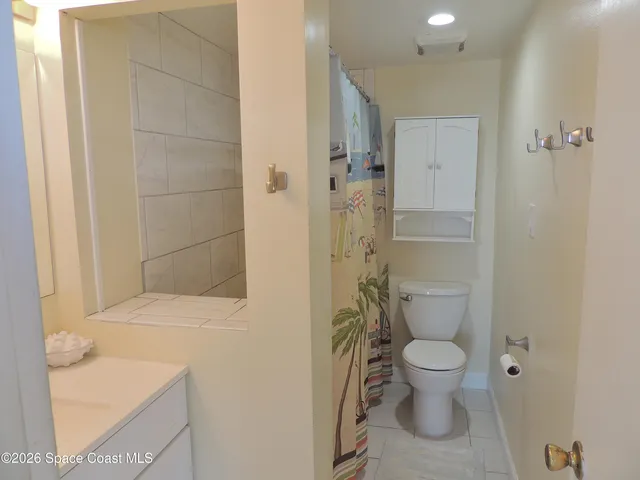 a white toilet sitting next to a bathroom sink