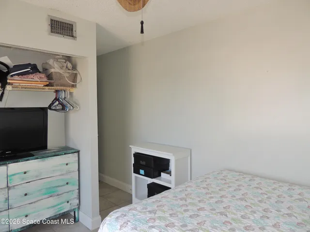 a bedroom with a bed and flat screen tv