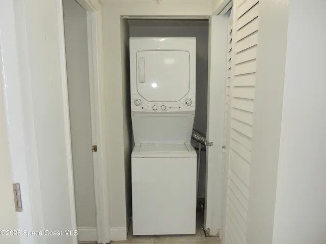 a view of a hallway with a washer and dryer