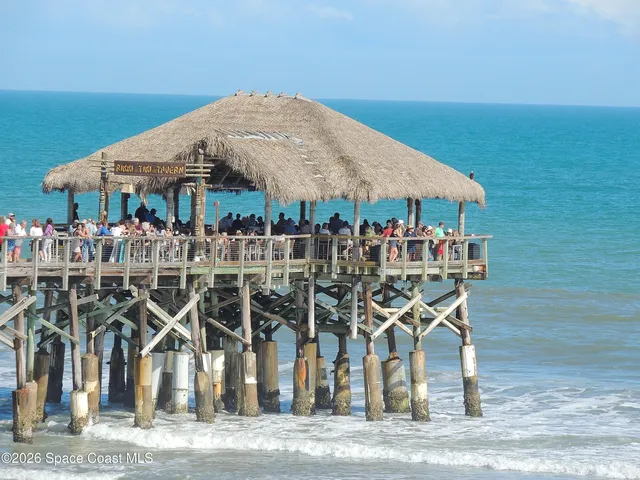 a balcony with table and chairs