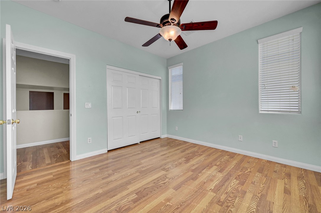 977 Sparkling Light Street Henderson, NV 89052 - Photo 57 of 75 This spacious bedroom offers ample natural light and durable flooring, creating a comfortable living space.