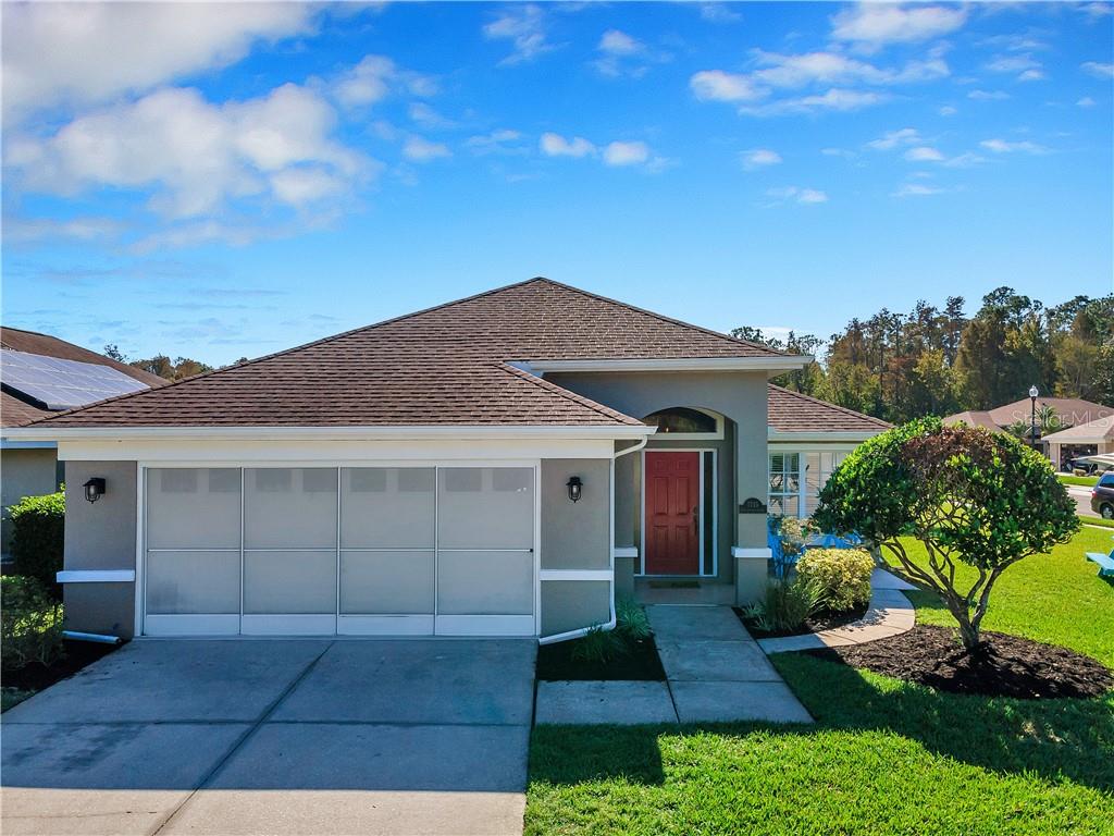 7735 Craighurst Loop New Port Richey, FL 34655 - Photo 1 of 1 a front view of a house with a garden