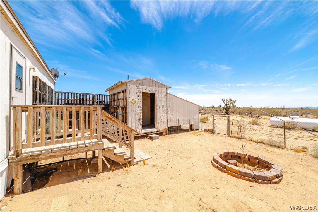 16435 South Wyatt Earp Road Yucca, AZ 86438 - Photo 20 of 57 Outdoor deck with wood railing and steps