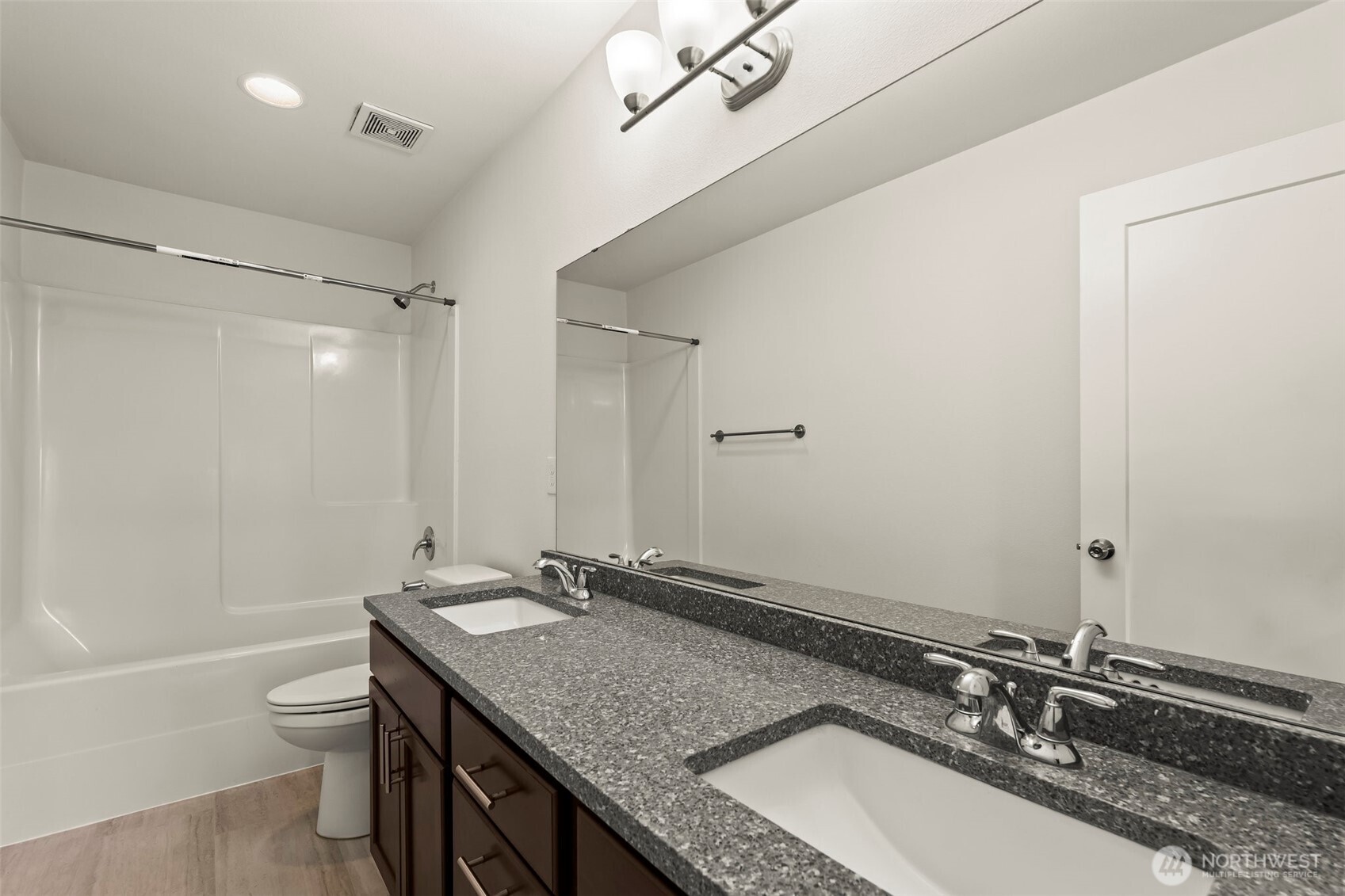 1080 East Old Ranch Road, Unit A1A2 Allyn, WA 98524 - Photo 28 of 35 a bathroom with a granite countertop sink a toilet a mirror and shower